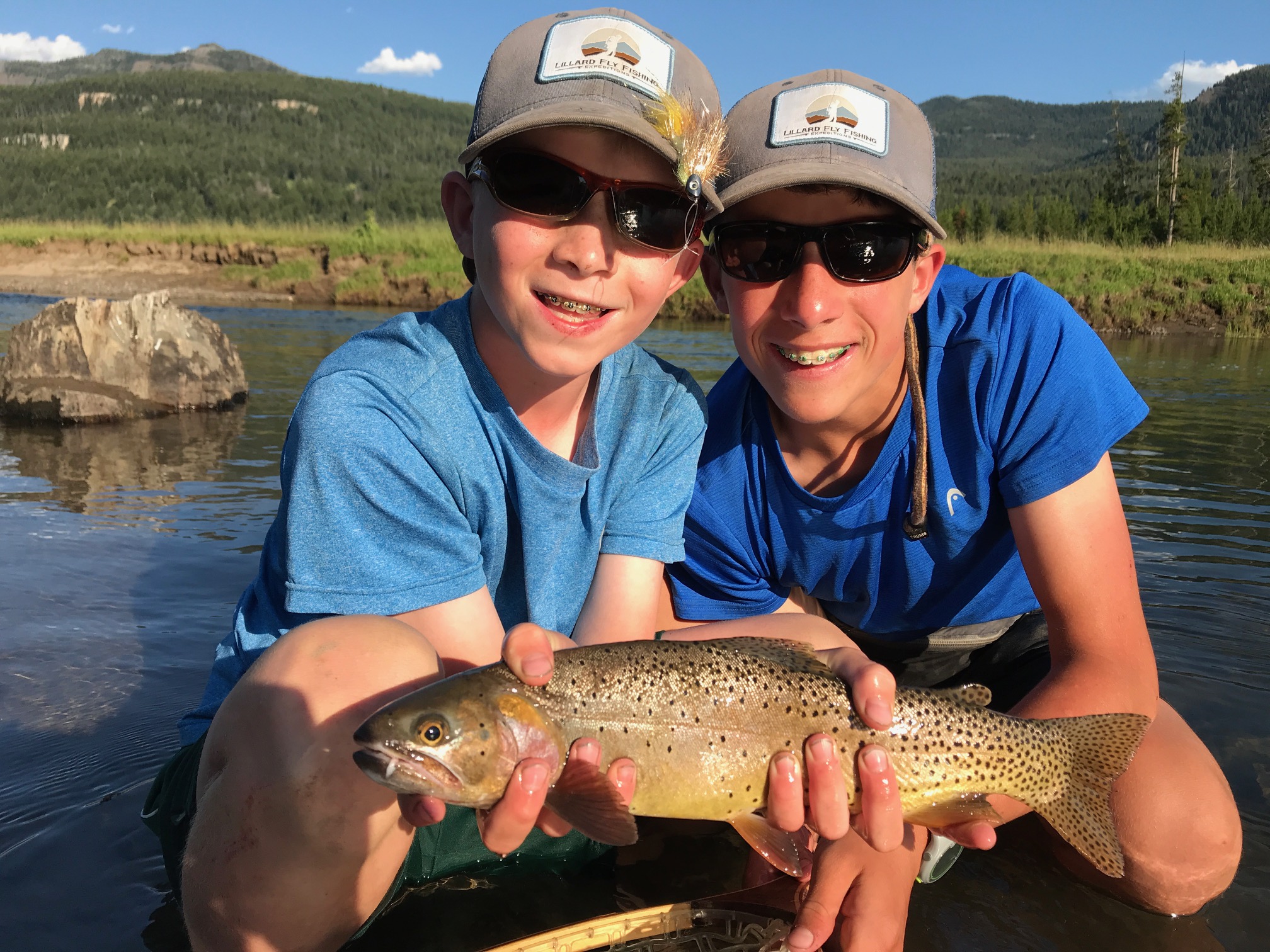 Two people holding a fish