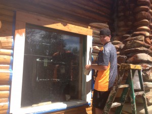 Alex painting some windows for future volunteers to enjoy.