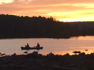 Paddling back to camp as the sun sets in the distance. 