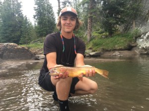Riley with one of the big and colorful trout that make Slough Creek so famous.